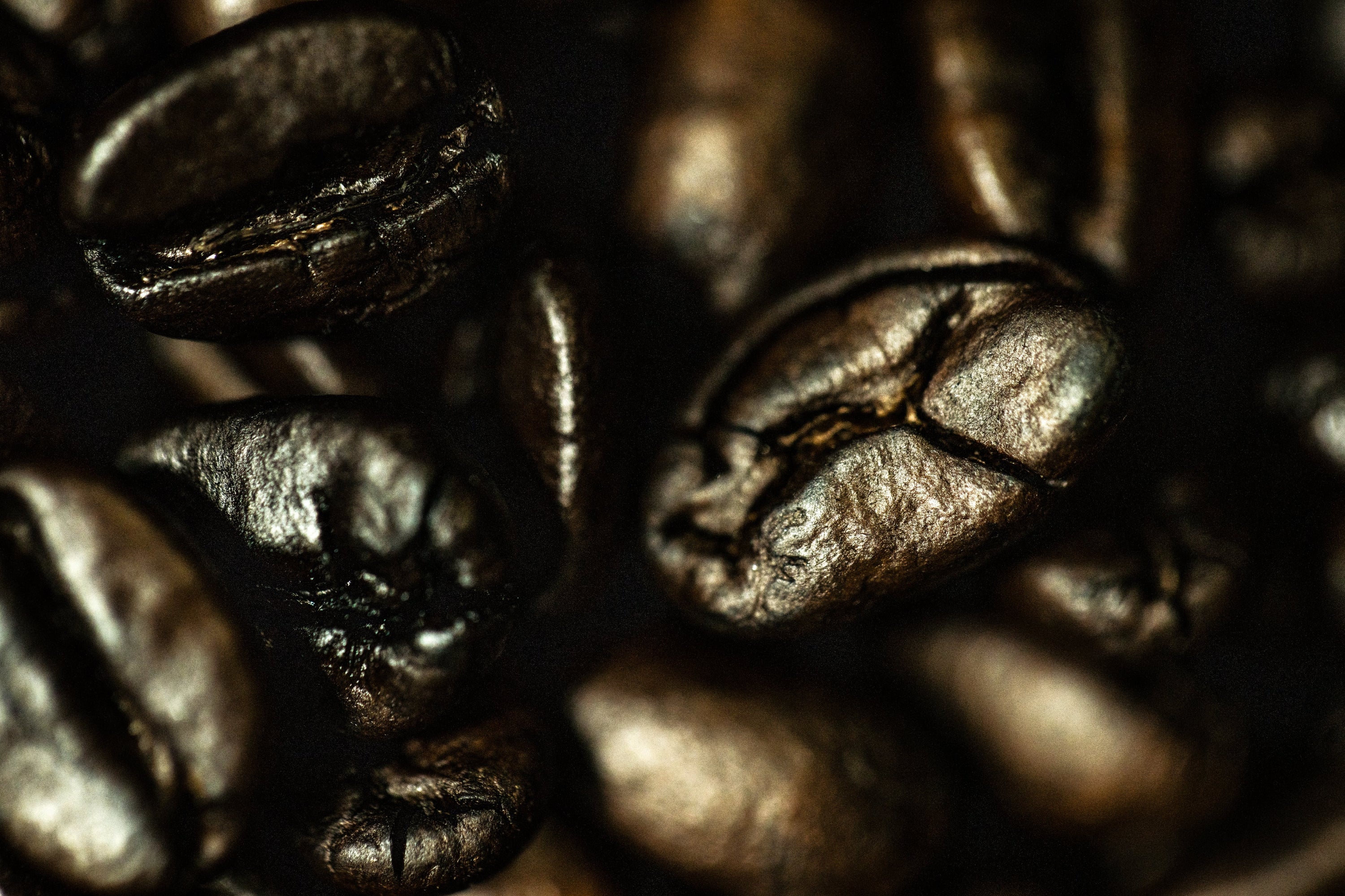 Close-up of roasted coffee beans with a dark background